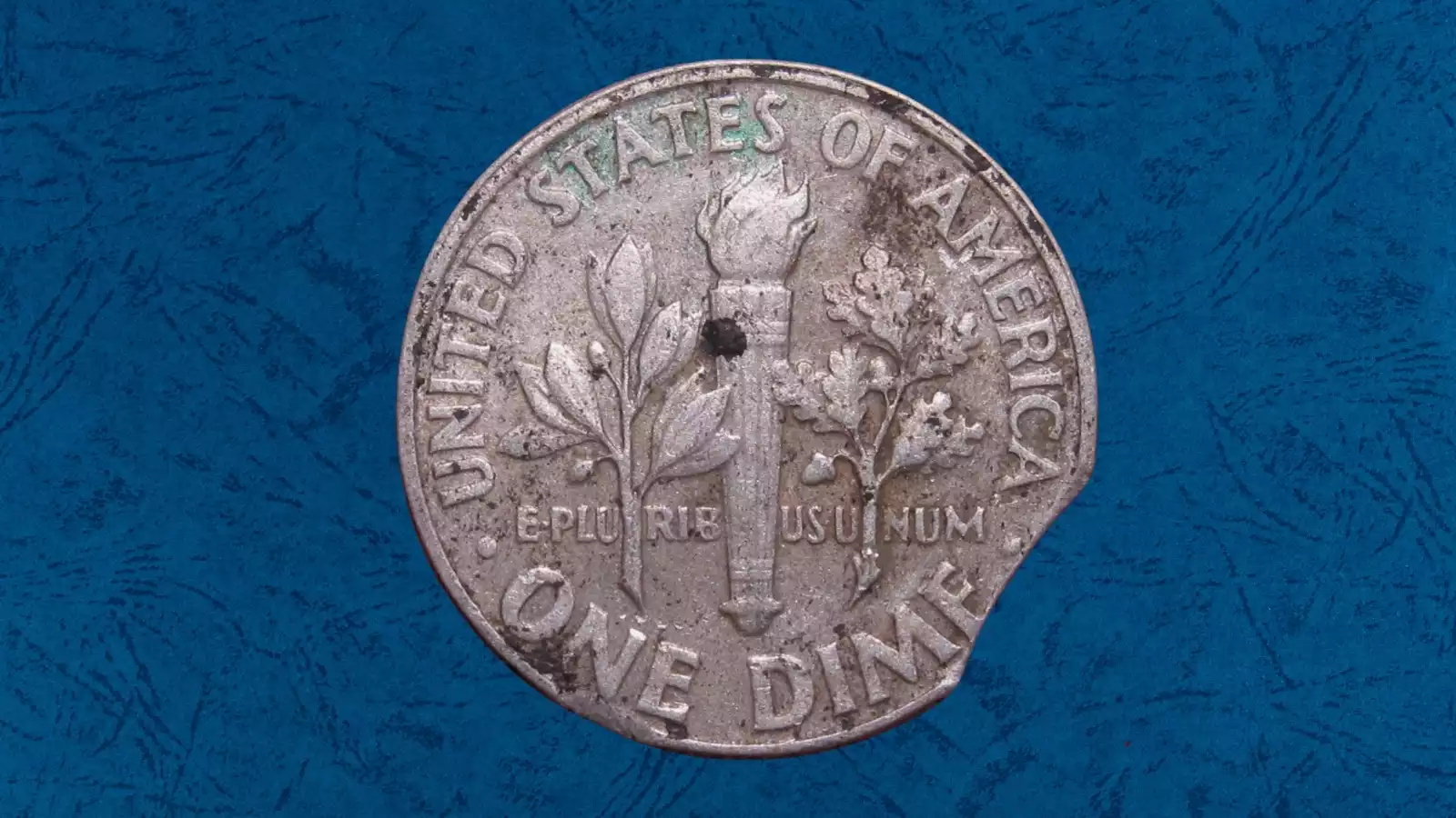 2001 dime clipped planchet error with curved section missing from coin edge showing Blakesley effect